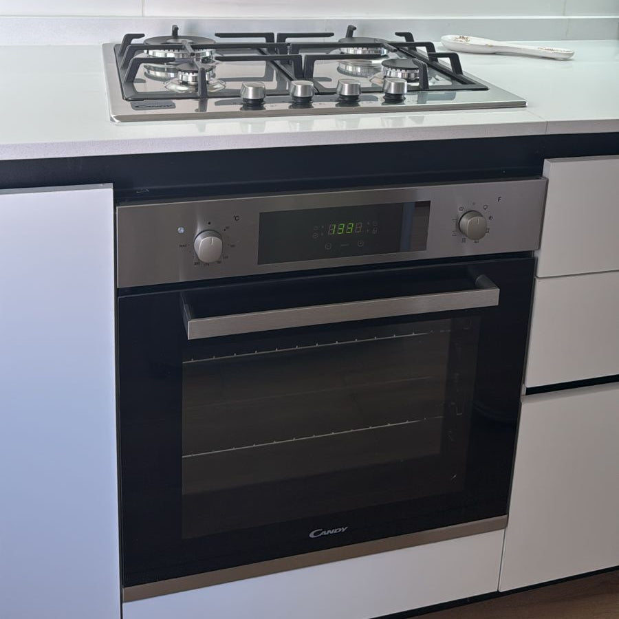 Horno empotrable Candy con anafe a gas integrado en acero inoxidable