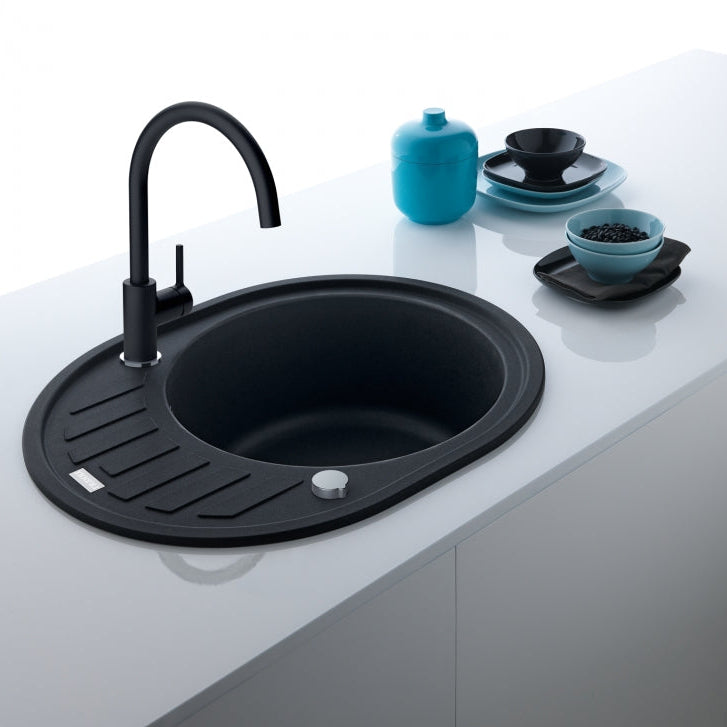 Un grifo de cocina Franke Mythos Masterpiece (115.0711.554) antracita instalado en un fregadero de una isla de cocina moderna con encimera de cuarzo blanco y muebles de diseño minimalista.